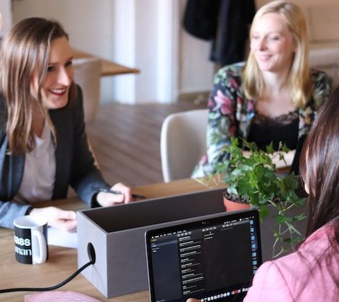 people having a discussion near an office table